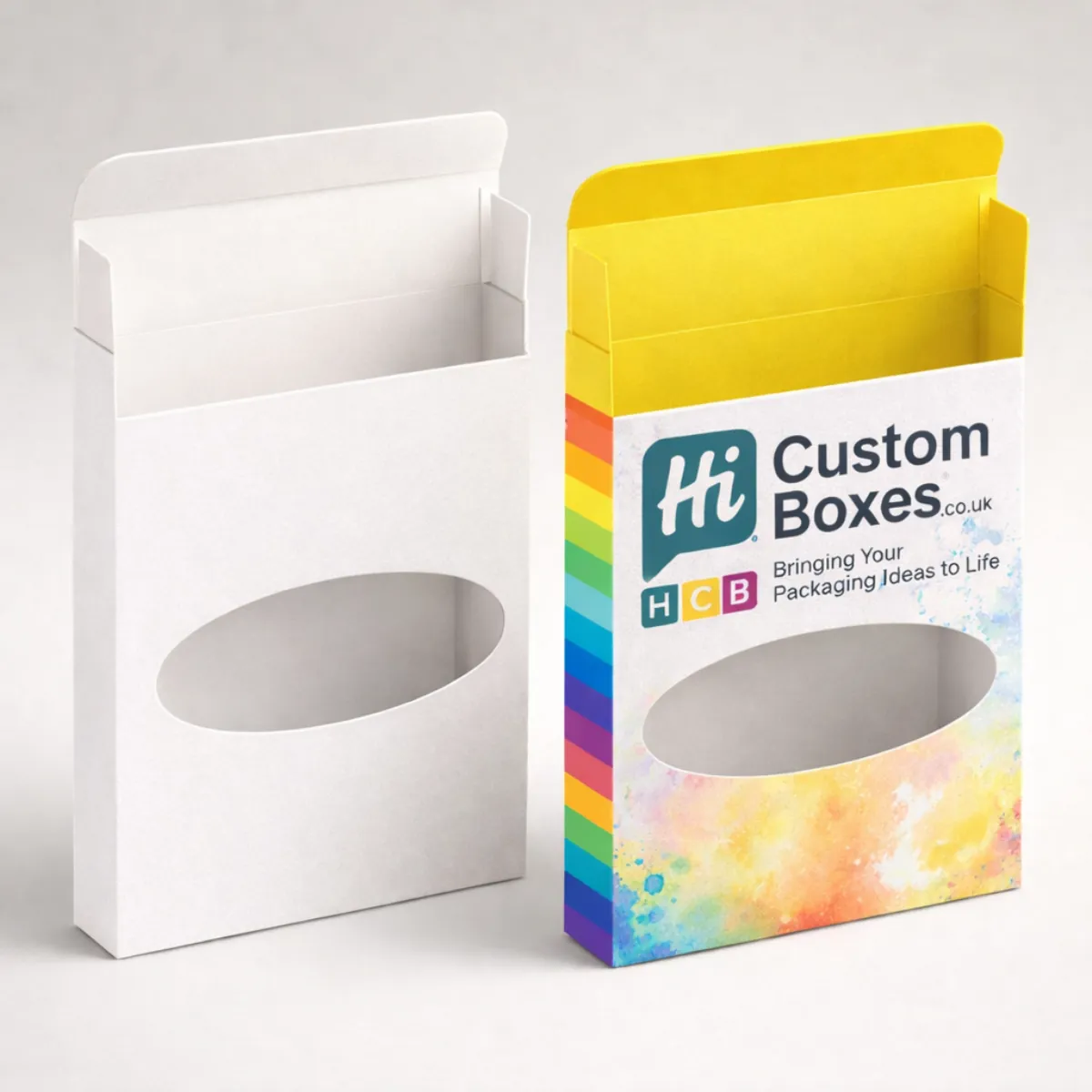 Two cardboard pencil boxes with oval windows; one is plain white, the other features a colourful rainbow design. class=
